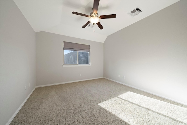 carpeted spare room featuring ceiling fan and vaulted ceiling