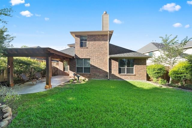 rear view of property with a patio area and a lawn