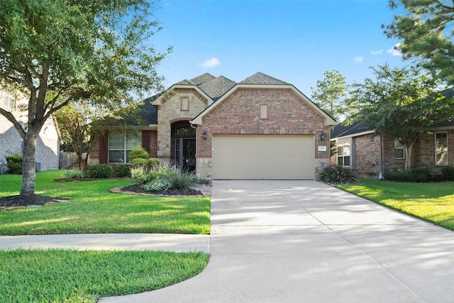 view of front of house with a garage and a front lawn