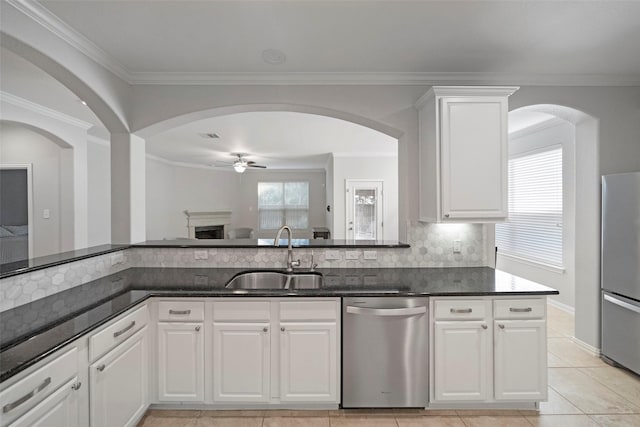 kitchen featuring white cabinetry, sink, ornamental molding, and appliances with stainless steel finishes