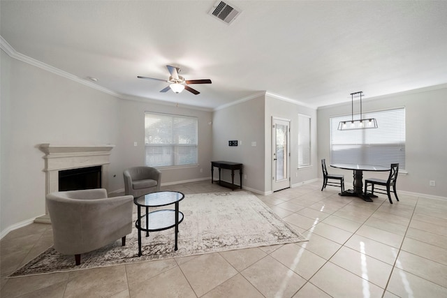 tiled living room featuring ceiling fan, plenty of natural light, and crown molding