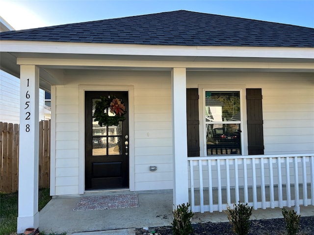 view of exterior entry with covered porch