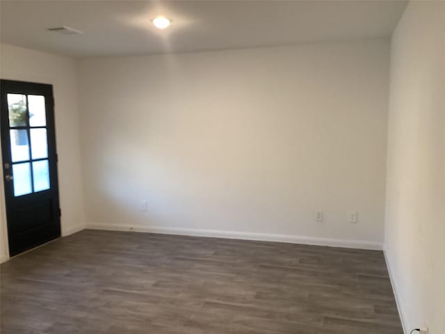 spare room featuring dark hardwood / wood-style flooring