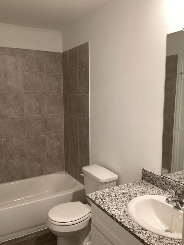 full bathroom with vanity, toilet, and tiled shower / bath