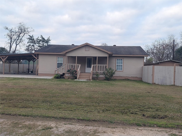 view of front facade with a front lawn and a carport