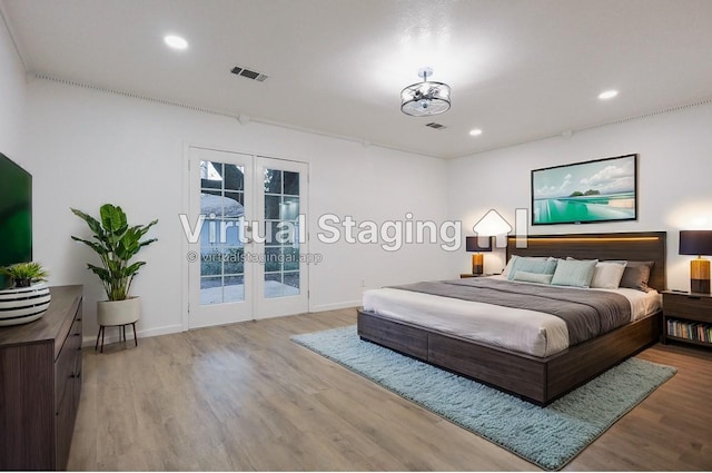 bedroom featuring french doors, access to outside, and light hardwood / wood-style flooring