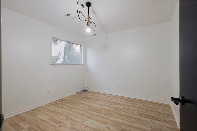 spare room featuring light hardwood / wood-style flooring