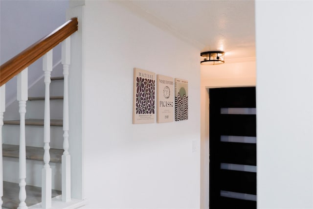 staircase featuring a textured ceiling