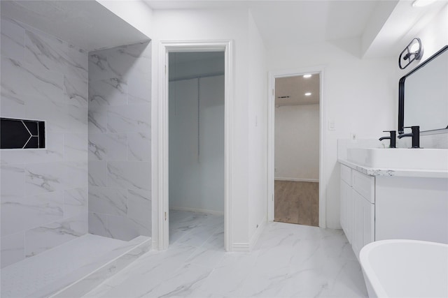 bathroom with vanity and tiled shower