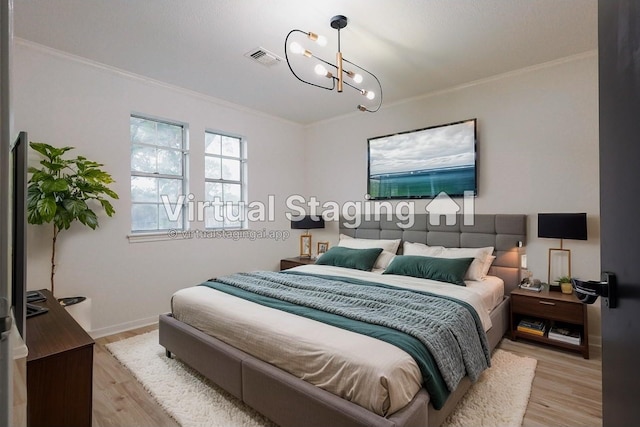 bedroom with light wood-type flooring, an inviting chandelier, and ornamental molding