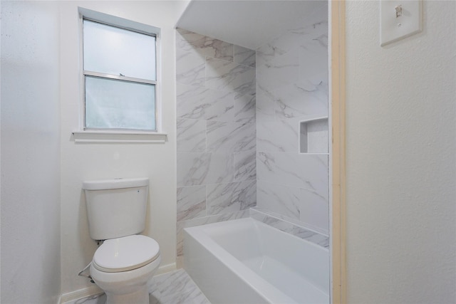 bathroom with tiled shower / bath combo and toilet