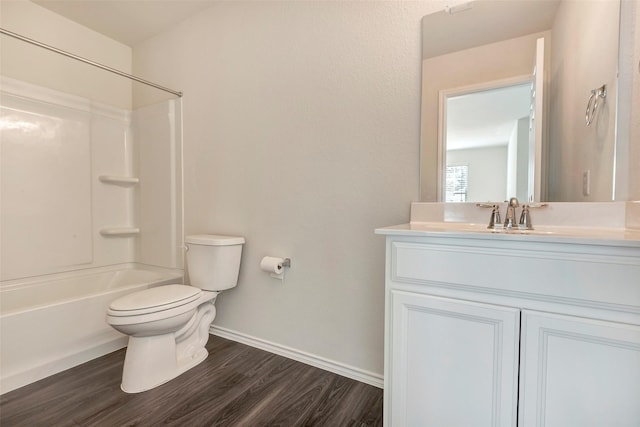 full bathroom featuring hardwood / wood-style flooring, shower / washtub combination, toilet, and vanity