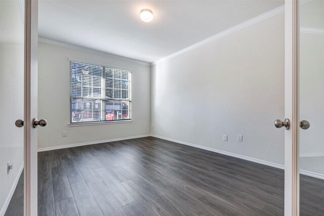 unfurnished room featuring dark wood-type flooring, crown molding, and french doors