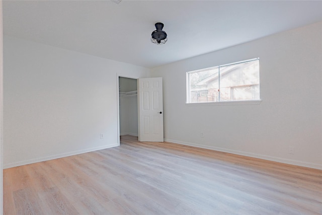 unfurnished bedroom featuring a closet and light hardwood / wood-style floors