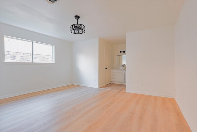 spare room with light hardwood / wood-style floors