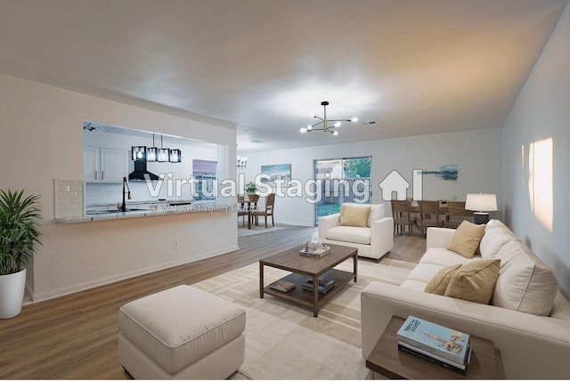 living room featuring light hardwood / wood-style floors and a notable chandelier