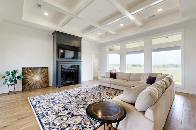 living room with hardwood / wood-style flooring, a fireplace, beamed ceiling, and coffered ceiling