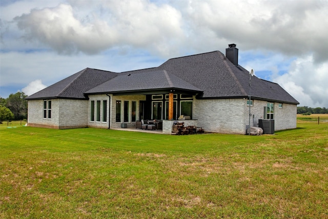 back of house featuring a yard, a patio, and central air condition unit