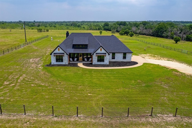 view of front facade featuring a rural view and a front yard