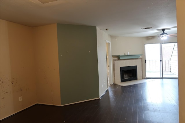 unfurnished living room featuring hardwood / wood-style flooring, a fireplace, and ceiling fan