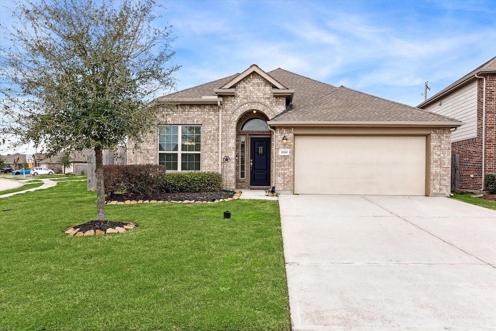 view of front facade with a garage and a front lawn