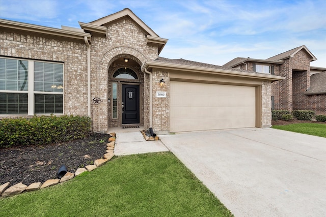 view of front of house with a front yard and a garage