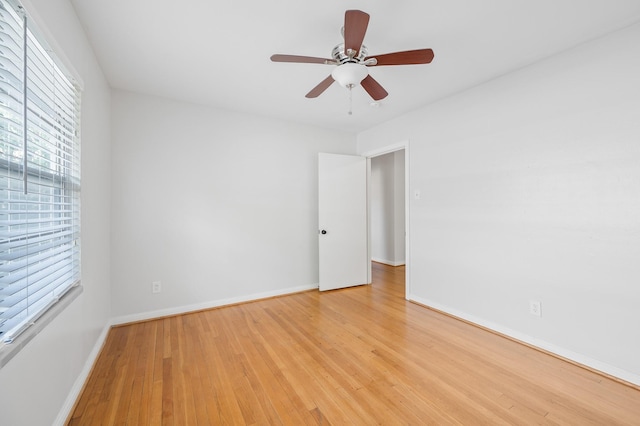 empty room with light wood-type flooring and ceiling fan