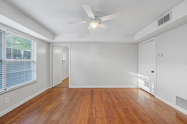 empty room with ceiling fan and dark wood-type flooring