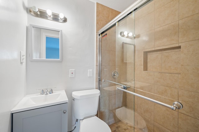 bathroom with vanity, an enclosed shower, and toilet