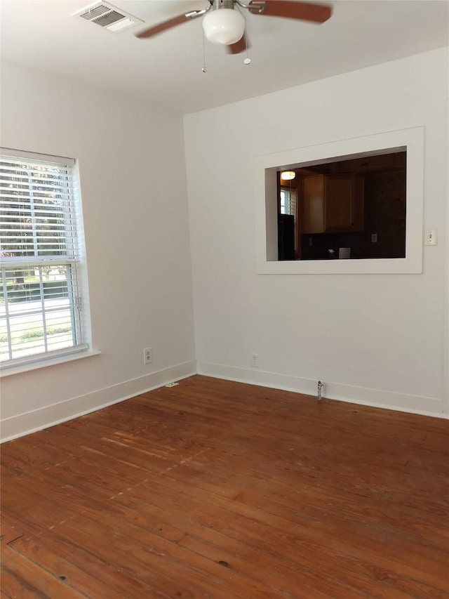 empty room featuring dark hardwood / wood-style flooring and ceiling fan