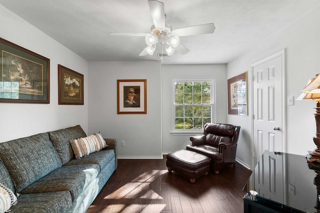 living room with ceiling fan and dark wood-type flooring