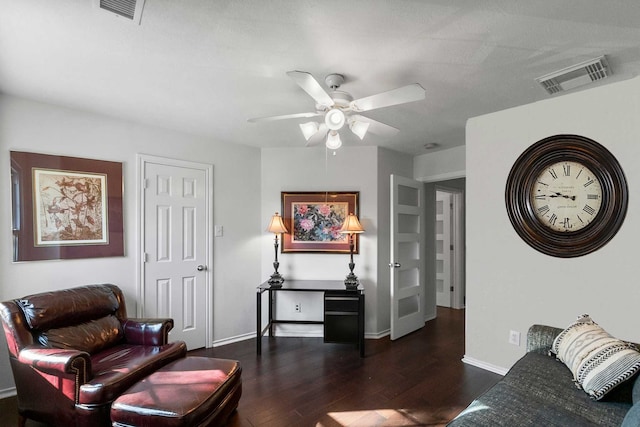 living room with ceiling fan and dark hardwood / wood-style flooring