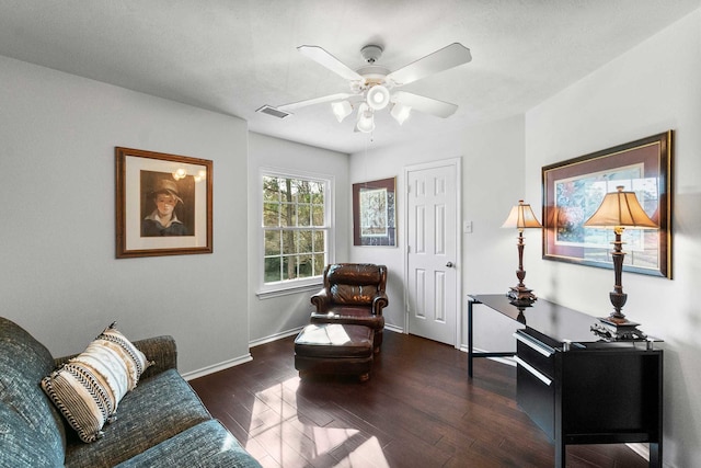 sitting room with dark hardwood / wood-style floors and ceiling fan