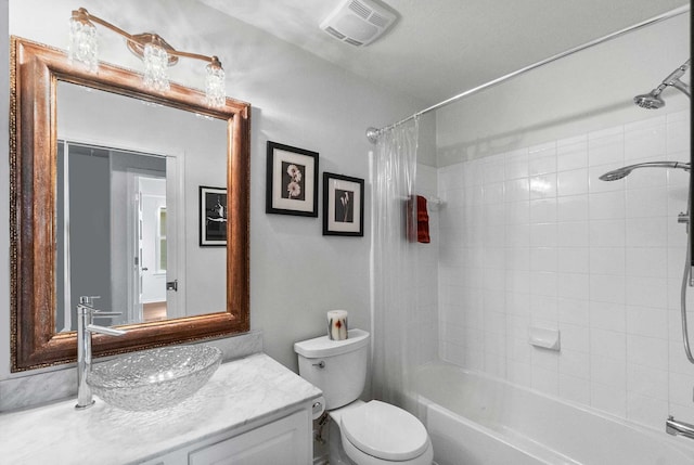 full bathroom with vanity, shower / bath combo, and toilet