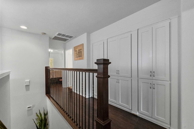 hallway with dark hardwood / wood-style flooring