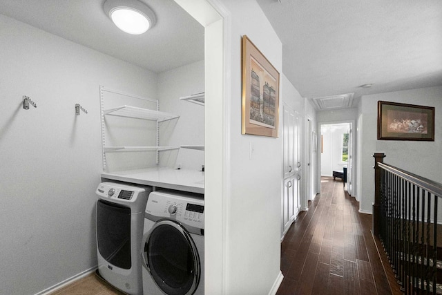 laundry area featuring dark hardwood / wood-style flooring and washing machine and clothes dryer