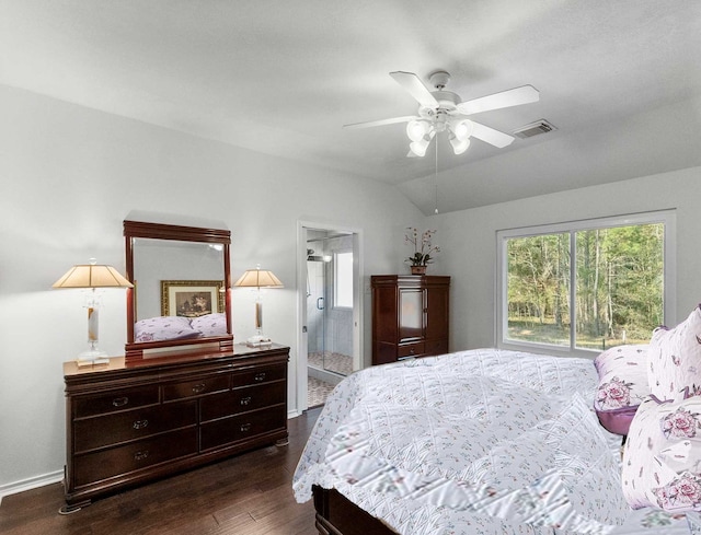 bedroom featuring ensuite bath, ceiling fan, dark wood-type flooring, and vaulted ceiling