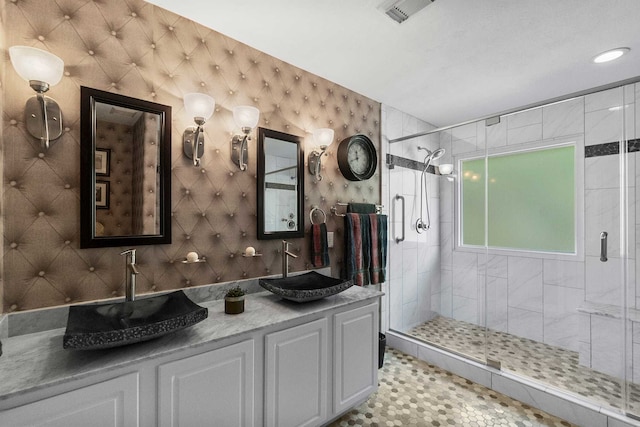 bathroom with vanity and a shower with shower door