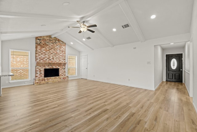 unfurnished living room featuring vaulted ceiling with beams, ceiling fan, light hardwood / wood-style floors, and a fireplace