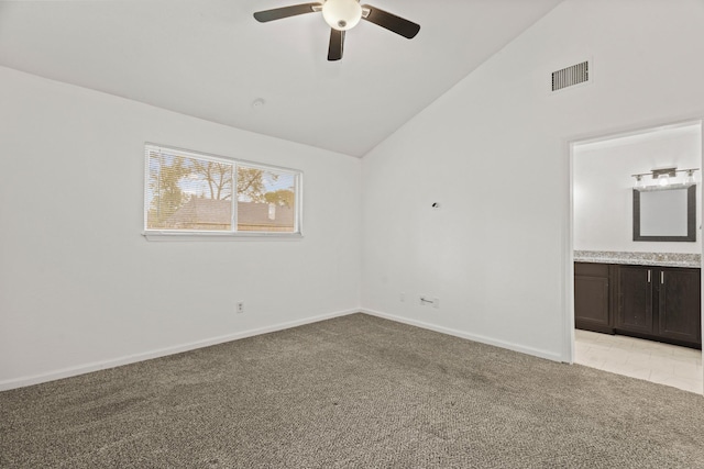 spare room with ceiling fan, light colored carpet, and lofted ceiling