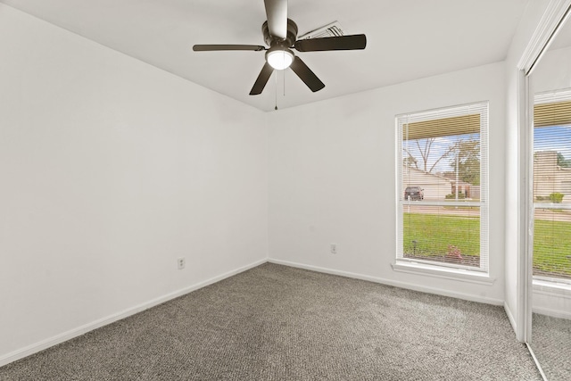 carpeted empty room featuring ceiling fan