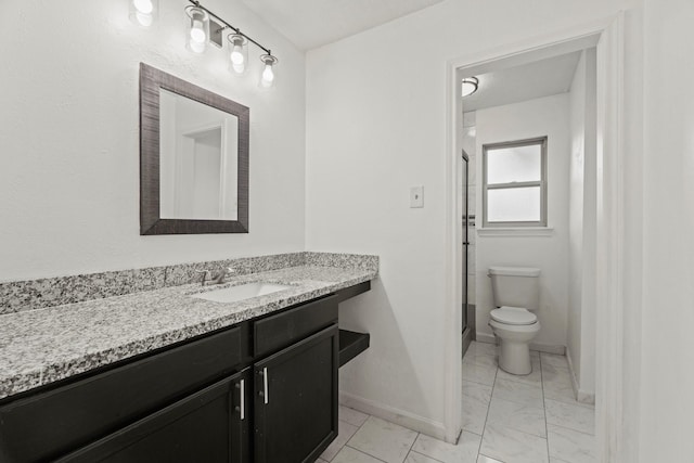 bathroom with vanity, toilet, and walk in shower