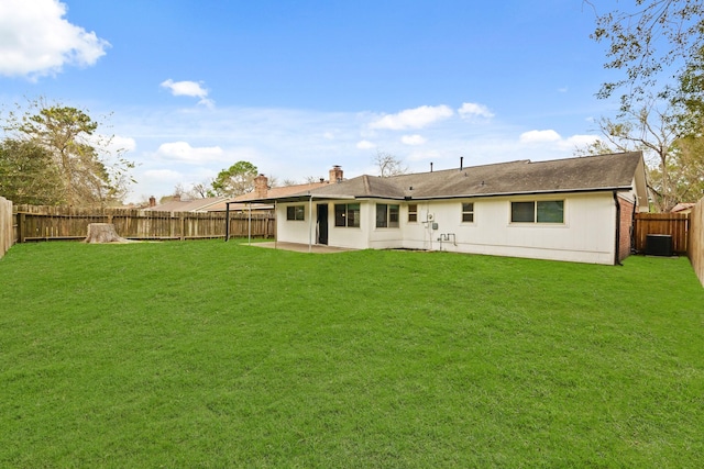 rear view of house featuring a yard and central air condition unit