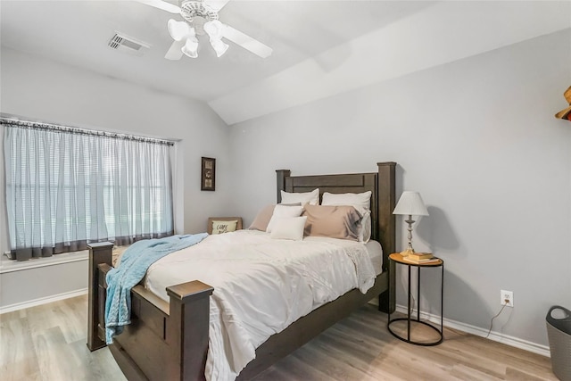 bedroom featuring ceiling fan, lofted ceiling, and light hardwood / wood-style flooring