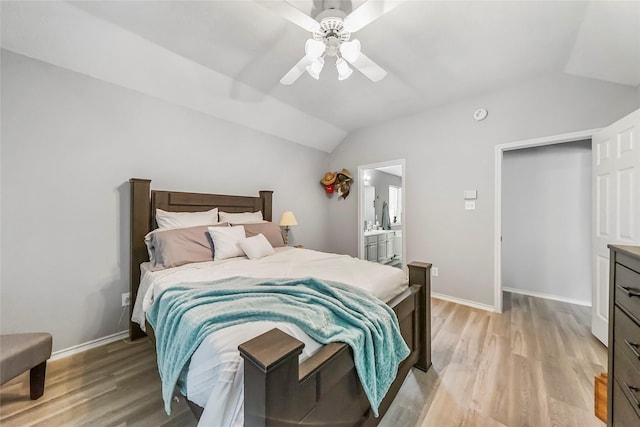 bedroom with ensuite bath, ceiling fan, lofted ceiling, and light wood-type flooring