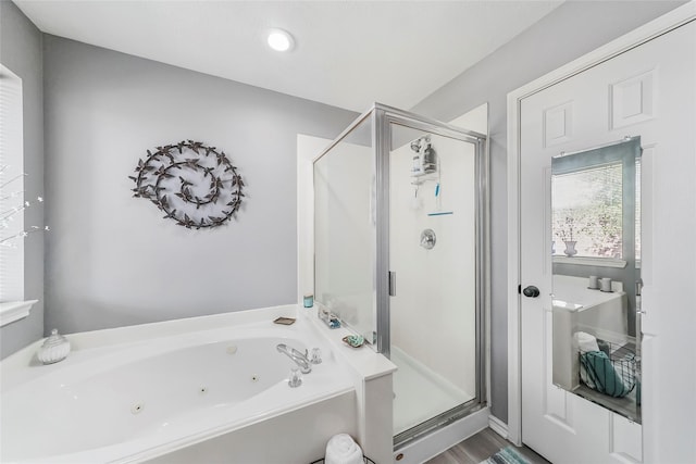 bathroom with wood-type flooring and independent shower and bath