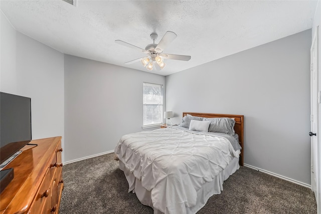 carpeted bedroom featuring ceiling fan and a textured ceiling