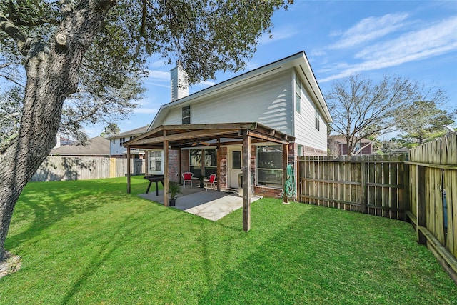 rear view of property featuring a yard and a patio