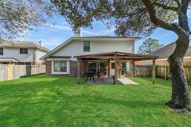 rear view of property with a yard and a patio