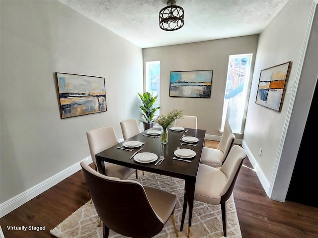 dining area with dark hardwood / wood-style floors